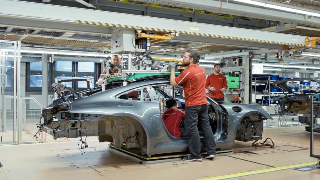 Production team executing assembly operations on automotive line