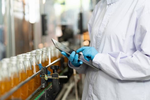 Food and beverage manufacturing worker ensuring quality control