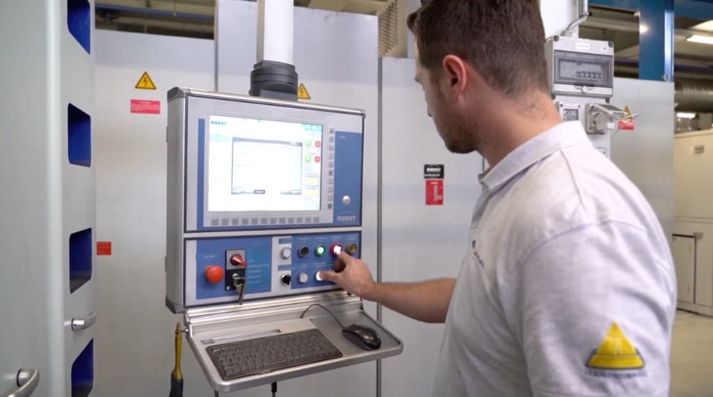 Machine operator using a connected worker app at a CNC control panel