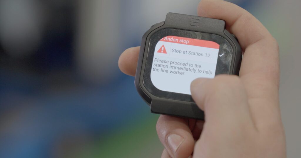 Smartwatch with Andon notification in a persons hand